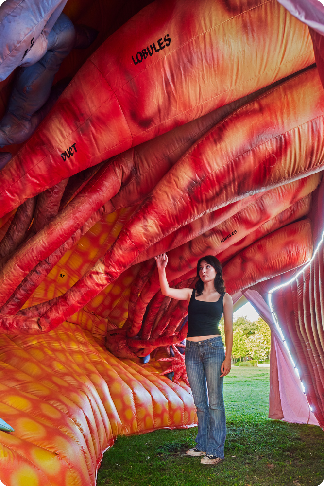 Health fair visitor tours the inside of our giant, inflatable Mega Breast to learn about breast cancer and breast cancer prevention.