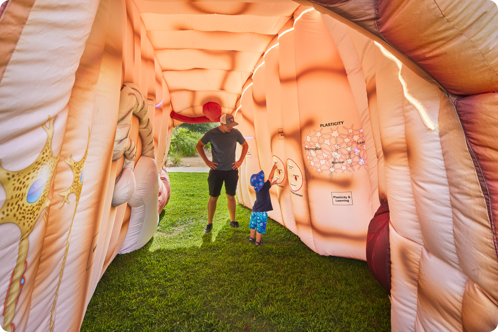 Vistors tour a mega inflatable at a health fair.