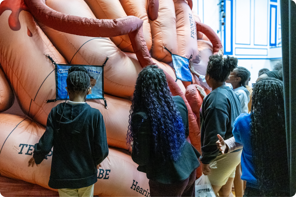 Students examine a Mega Inflatable at a school health education event.